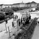 West Berliners on the right talk with East Berlin policemen through the barbed wire fence in 1961
